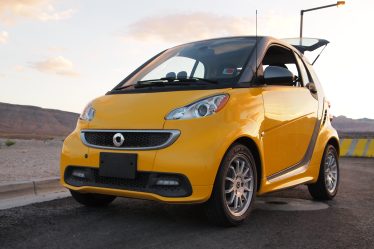 Yellow little Smart car